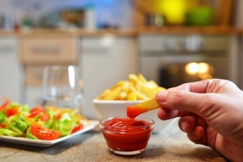 Salad and French fries with ketchup