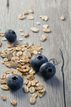 Healthy Muesli And Fresh Berries on wooden table