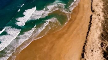 Beautiful aerial view of a beach with waves. Natural textures and colors