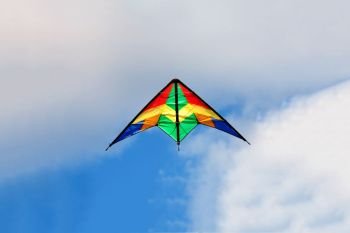 Colourful kite flying on a over blue sky
