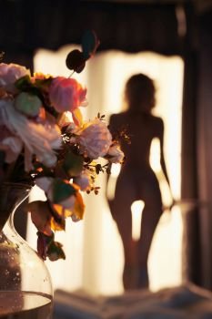 Lifestyle art photo of beautiful sensual blonde with flowers at the window. Home interior. Beautiful morning                              