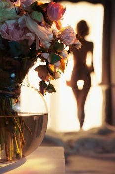 Lifestyle art photo of beautiful sensual blonde with flowers at the window. Home interior. Beautiful morning. Aroma bouquet                           