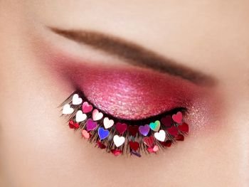 Eye Make-up Girl with a Heart. Valentine’s Day Makeup. Beauty Fashion. Eyelashes. Cosmetic Eyeshadow. Makeup Detail. Female Eye with Extreme Long False Eyelashes