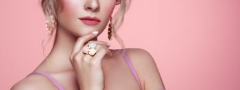 Beauty Woman with perfect Makeup and Manicure. Glamour Girl with Jewelry. Pink Lips and Nails. Precious Stones and Silver. Beauty girls Face isolated on light Background. Fashion photo