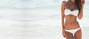 Pretty girl in bikini with perfect body at tropical sea beach. Pretty girl at the beach