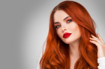 Glamour woman with long red hair on gray background. Glamour woman with long red hair