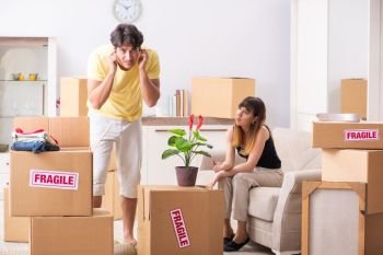 Young couple moving to new flat with fragile things