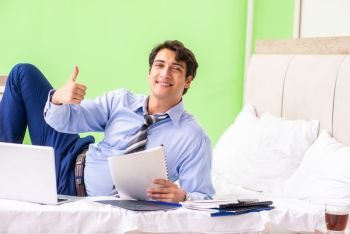 Businessman working overtime in hotel room