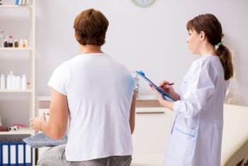 Male patient visiting young female doctor chiropractor . The male patient visiting young female doctor chiropractor 