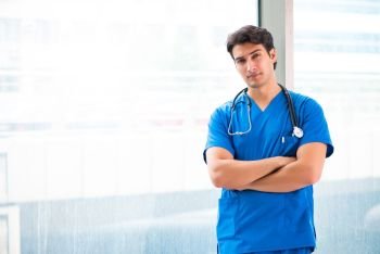 Young handsome doctor working in the hospital 