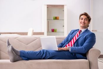 Young businessman working at home sitting on the sofa  . Young businessman working at home sitting on the sofa 