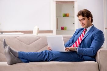 Young businessman working at home sitting on the sofa  . Young businessman working at home sitting on the sofa 