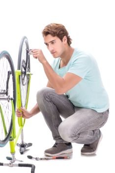 Man repairing his bike isolated on white background