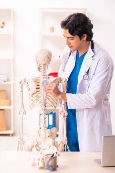 Young male doctor with skeleton 