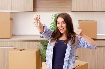 Young beautiful woman moving to new flat