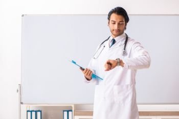 Young doctor in front of whiteboard 