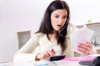 Young woman with receipts in budget planning concept 