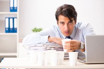 Young employee addicted to coffee