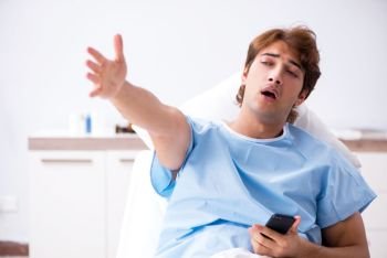 Young male patient lying on couch in hospital 
