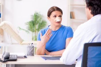 Woman visiting male doctor for plastic surgery  