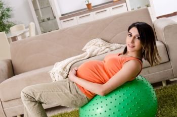 Young pregnant woman at home 