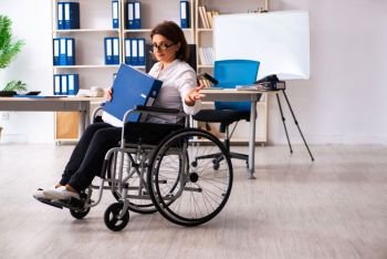 Female employee in wheel-chair at the office  