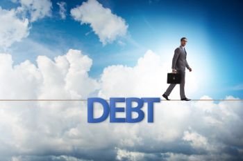 Debt and loan concept with businessman walking on tight rope