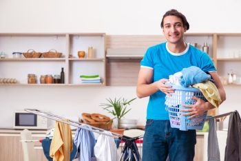 Young man husband doing clothing ironing at home 
