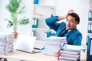 Young male employee unhappy with excessive work 