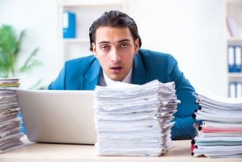 Young male employee unhappy with excessive work 