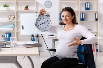 Old pregnant woman working in the office 