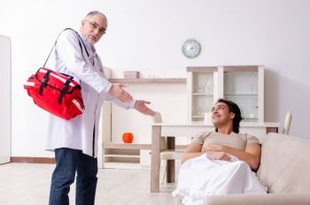 The old male doctor visiting young male patient  . Old male doctor visiting young male patient  