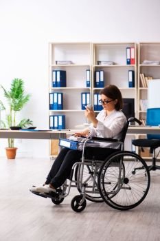Female employee in wheel-chair at the office  