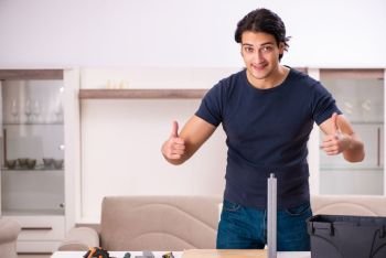 Young man repairing furniture at home 