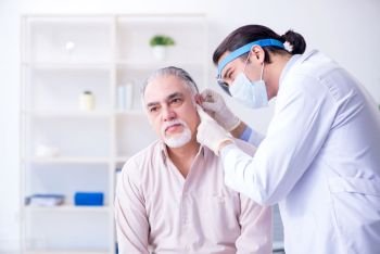 Male patient visiting doctor otolaryngologist