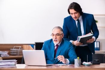 Young and old employees working together in the office 