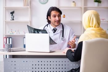 Female arab patient visiting male doctor. Female arab patient visiting male doctor 