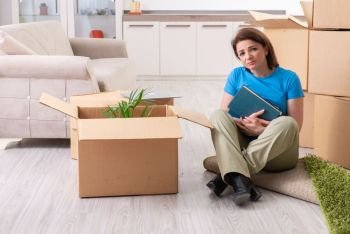 Middle-aged woman moving to new flat 