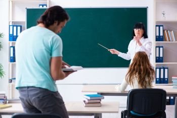 Old teacher and students in the classroom 