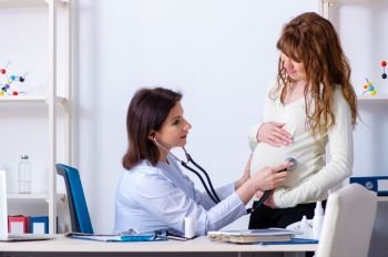 Young pregnant woman visiting experienced doctor gynecologist . Young pregnant woman visiting experienced doctor gynecologist