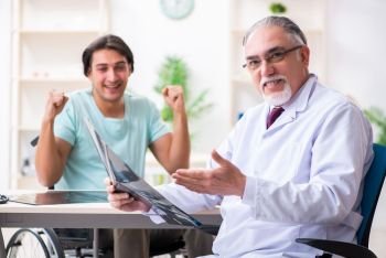 Male patient in wheel-chair visiting old doctor 
