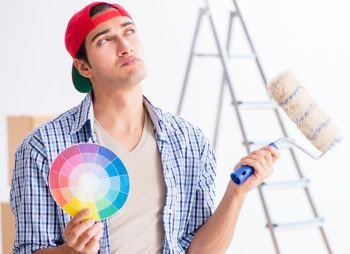 Young painter contractor choosing colors for home renovation