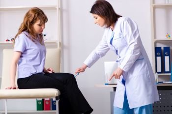Young woman visiting female doctor physiotherapist 
