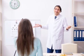 The young woman visiting male doctor oculist . Young woman visiting male doctor oculist 