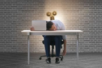 The employee losing energy from too much work. Employee losing energy from too much work