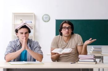 The two male students in the classroom . Two male students in the classroom 
