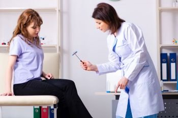 The young woman visiting female doctor physiotherapist . Young woman visiting female doctor physiotherapist 