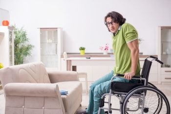 Young male student in wheelchair at home