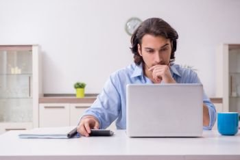 Young male employee working at home 