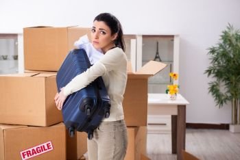 Young woman moving to new flat 